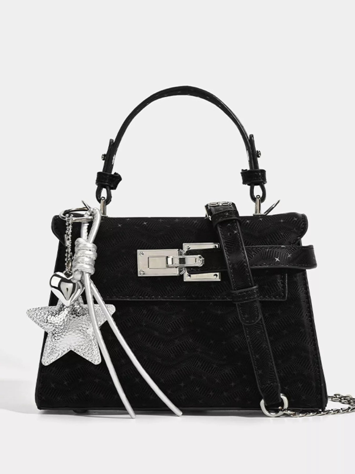 Black mini PU leather handbag with a structured silhouette, arched top handle, front buckle strap, silver hardware, and decorative star and key charms.