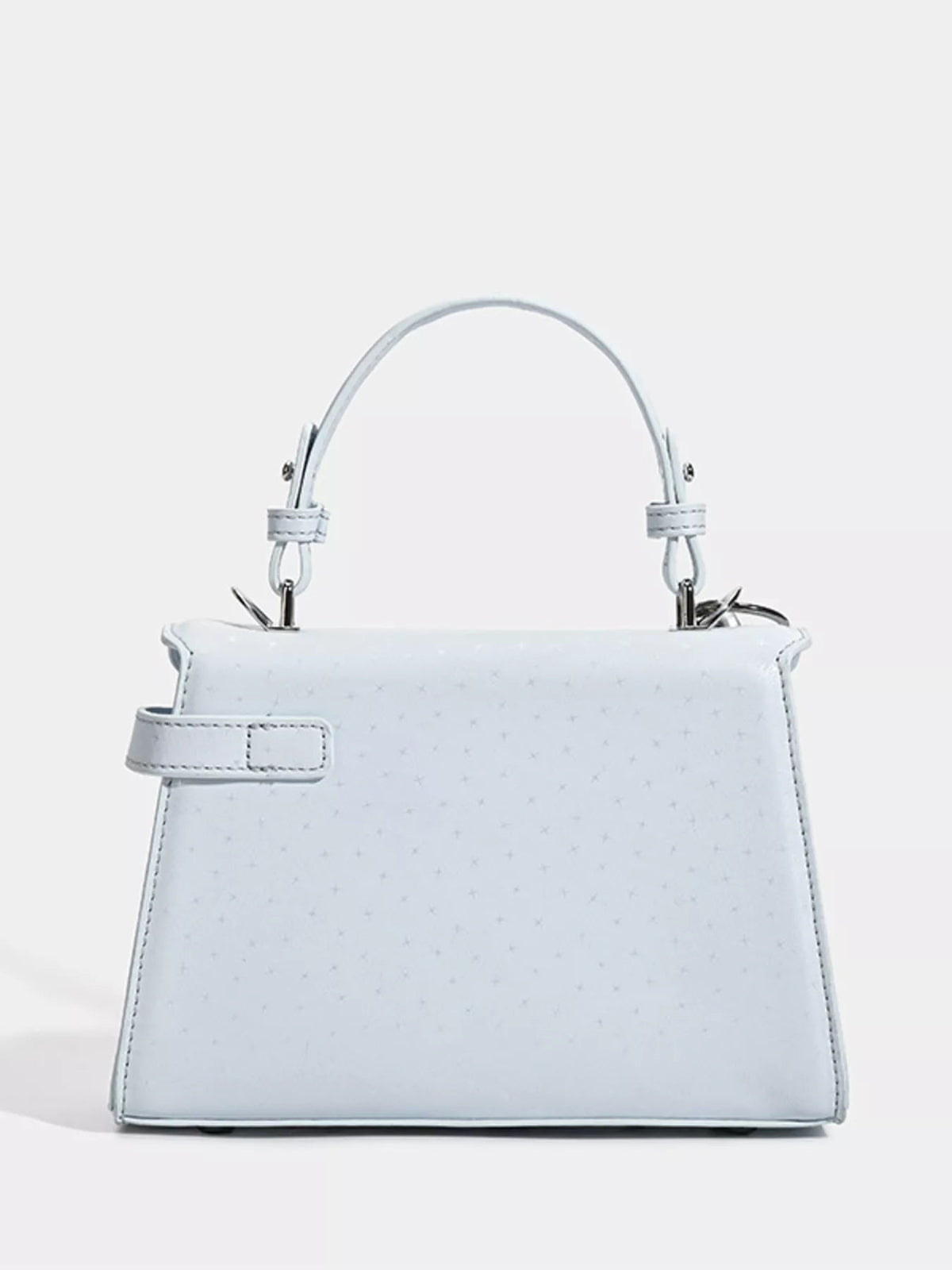White mini PU leather handbag with a structured trapezoidal silhouette, rounded top handle, stitched edges, and a side strap detail.