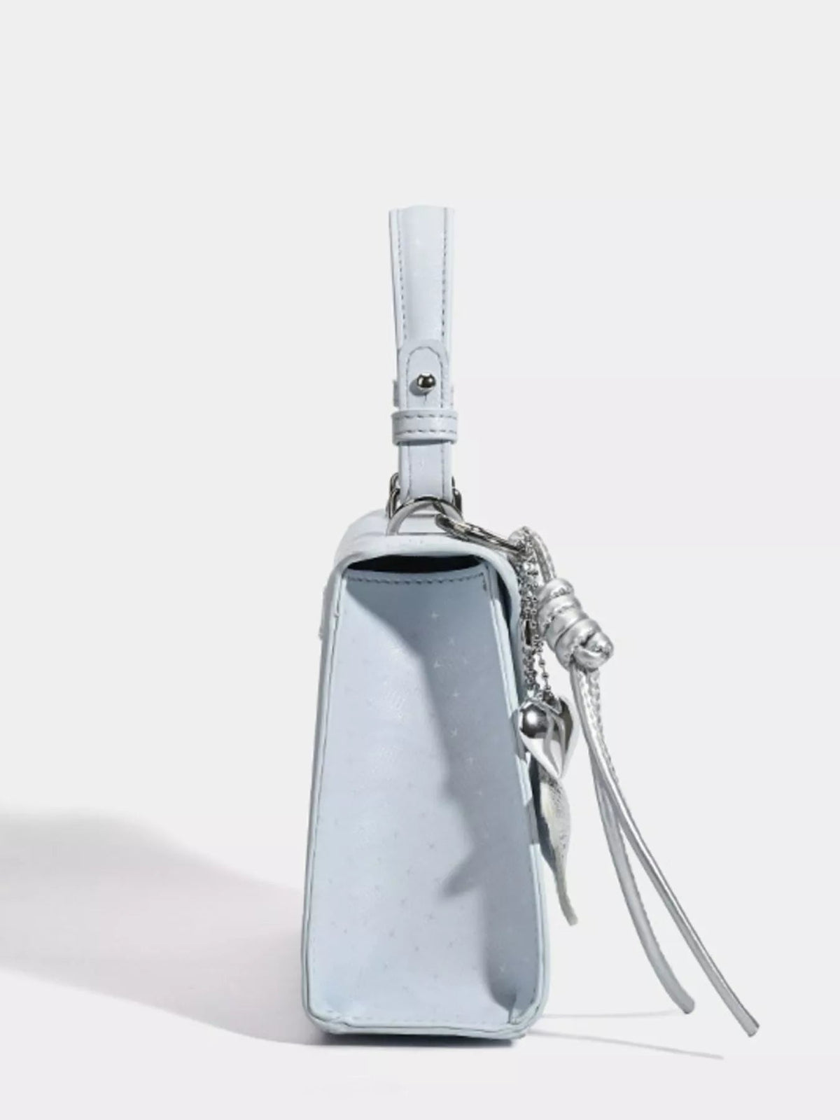 A mini light blue PU leather handbag with a structured rectangular silhouette, stitched edges, top wrist strap, side tassel details, and a buckle accent.