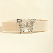 Cream elastic belt with a substantial woven band and polished butterfly alloy buckle, showcasing a feminine statement accent and defined waist silhouette.