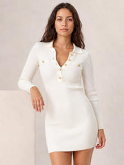 Model poses in a white ribbed knit polo sweater dress with long sleeves, a collared V-neck, button details, fitted silhouette, and straight mini hem.
