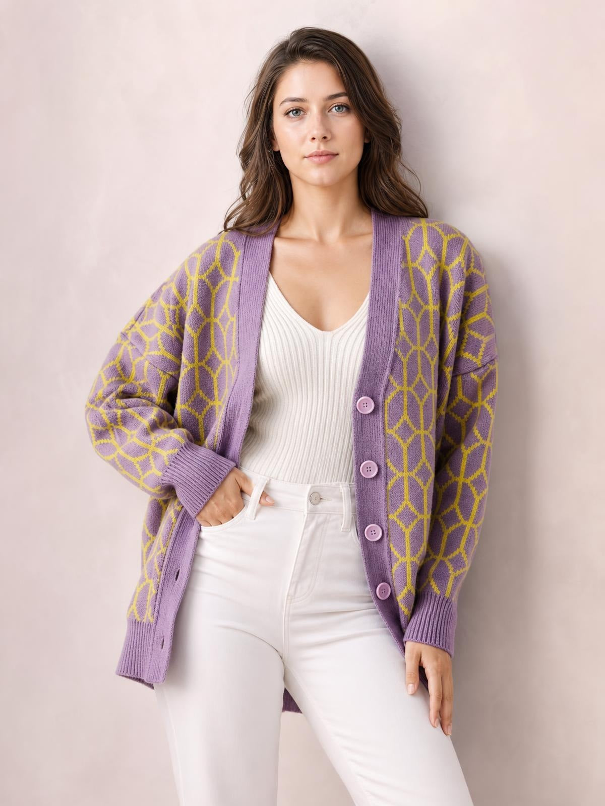 A woman poses in a lavender long-sleeve cardigan with a yellow geometric pattern, button front, ribbed trim, and a relaxed hip-length silhouette.
