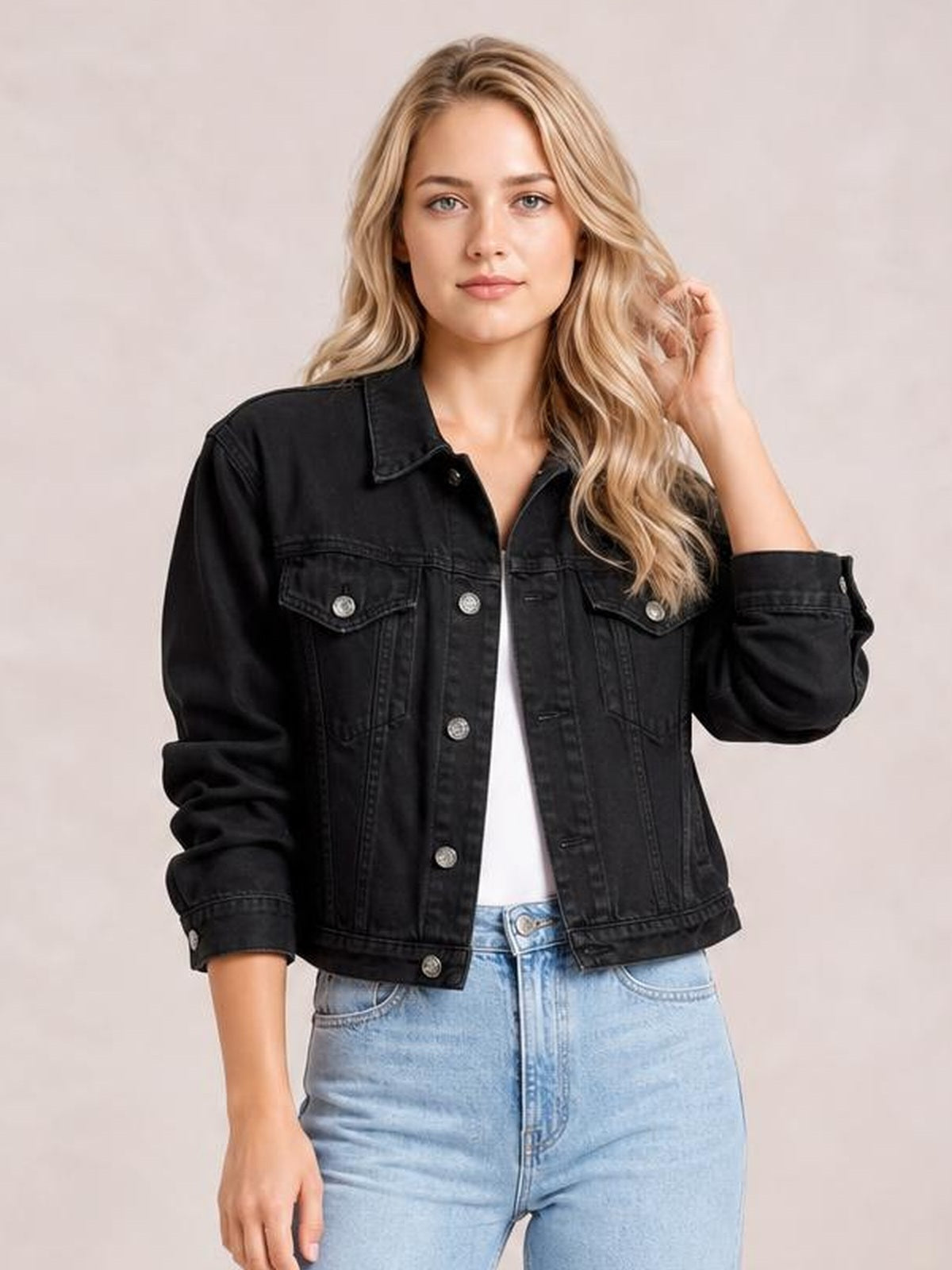 Model wears a black button-up long sleeve denim jacket with a relaxed silhouette, pointed collar, chest flap pockets, and rolled cuffs.