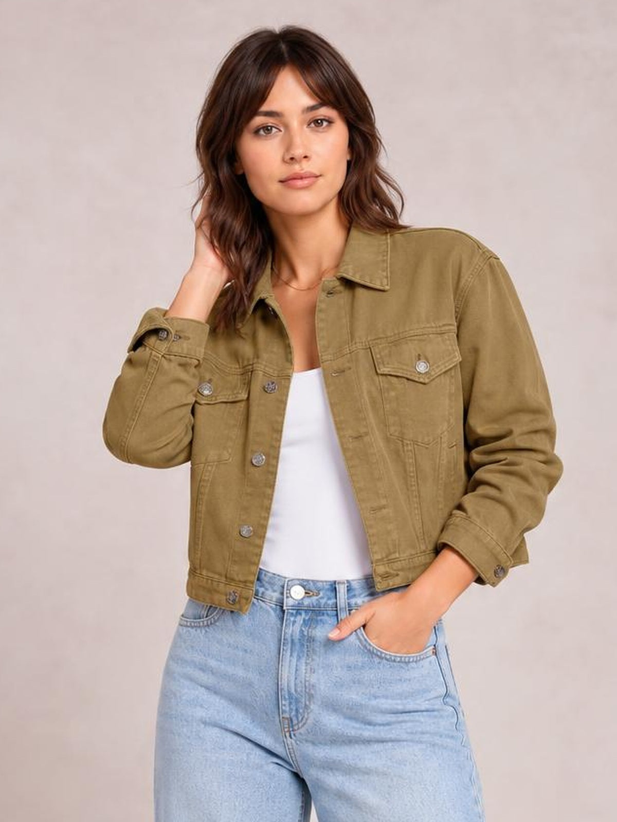 Model wears a tan button-up long-sleeve denim jacket with a pointed collar, chest flap pockets, cuffed sleeves, and a relaxed silhouette.