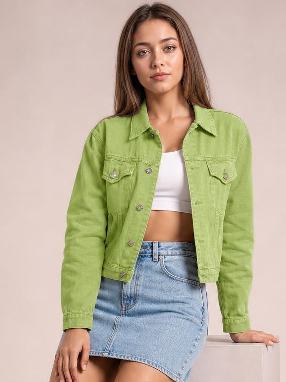 Model wears a lime green long-sleeve denim jacket with a button front, pointed collar, flap chest pockets, and a cropped straight silhouette.