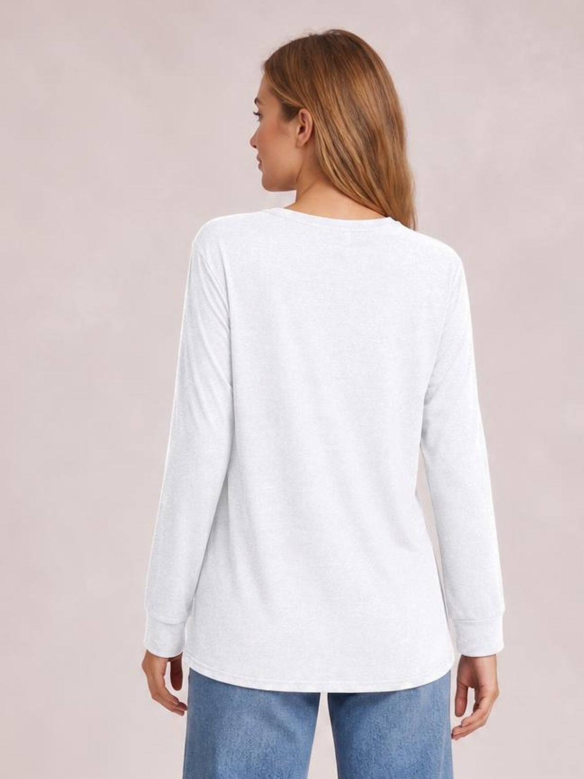 Model shown from behind wearing a white long sleeve top with a relaxed straight silhouette, smooth construction, and a gently curved hem.