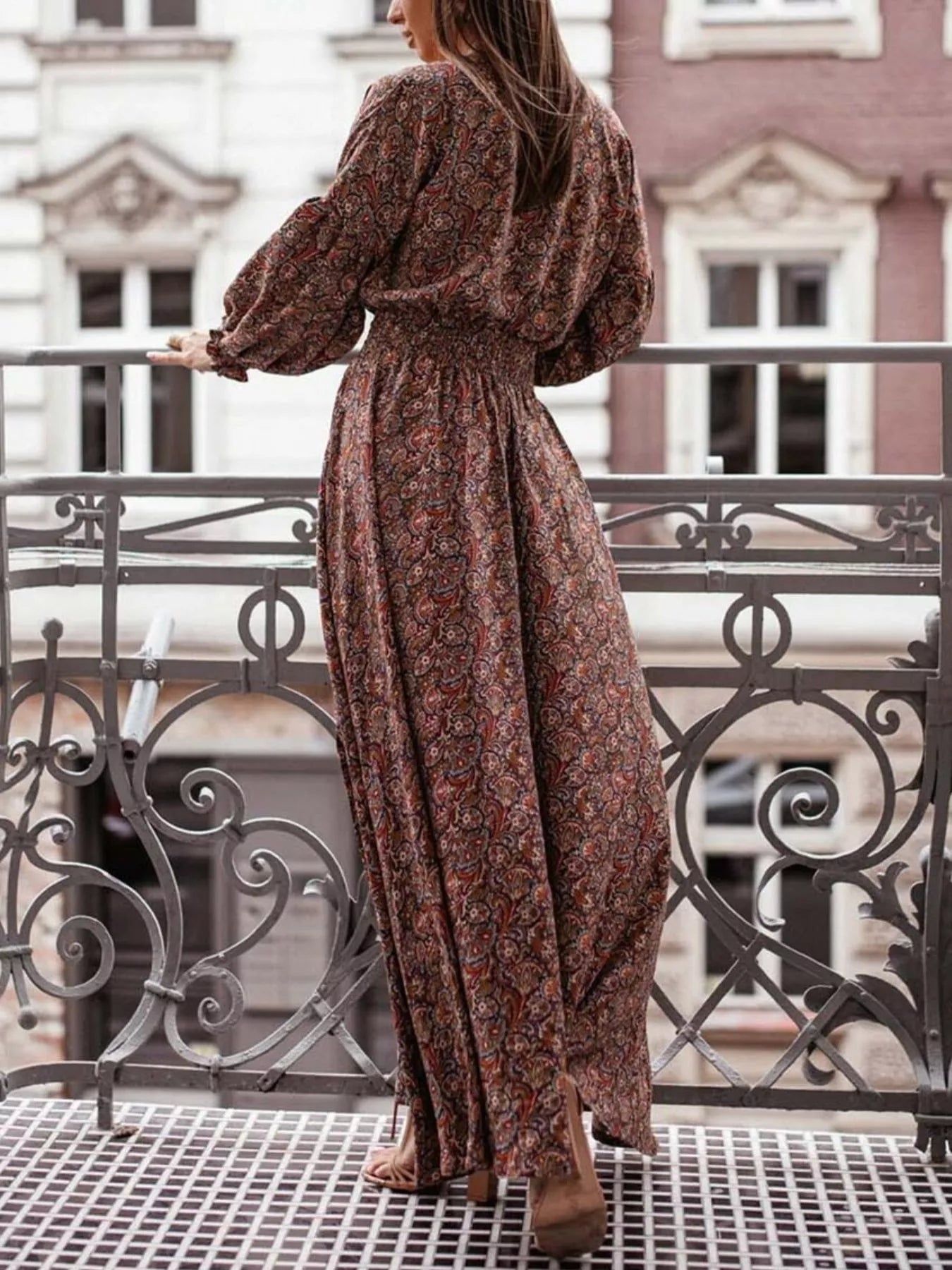 Bohemian floral printed maxi dress with plunging neckline, ruched waist, tiered skirt, and long flowy sleeves