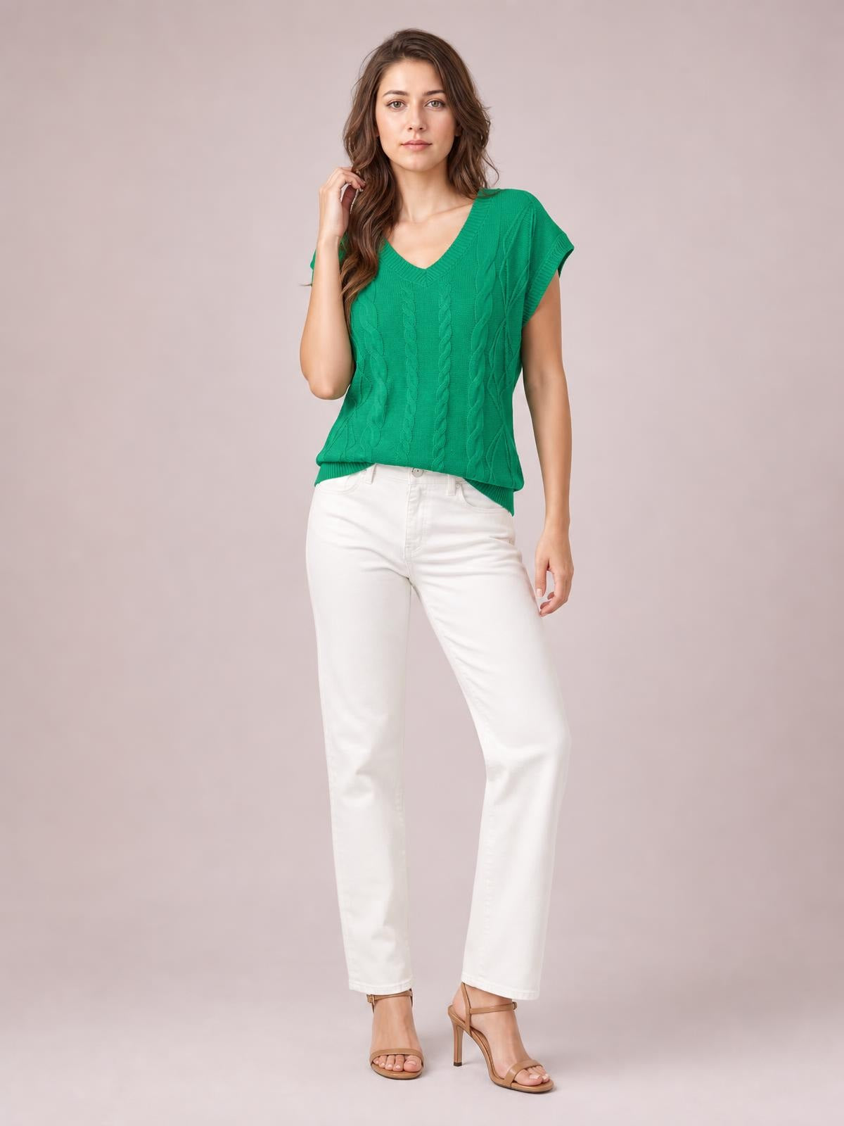 Model wearing a bright green cable-knit V-neck short sleeve knit top with a relaxed silhouette, ribbed neckline and hem, and textured braided construction.