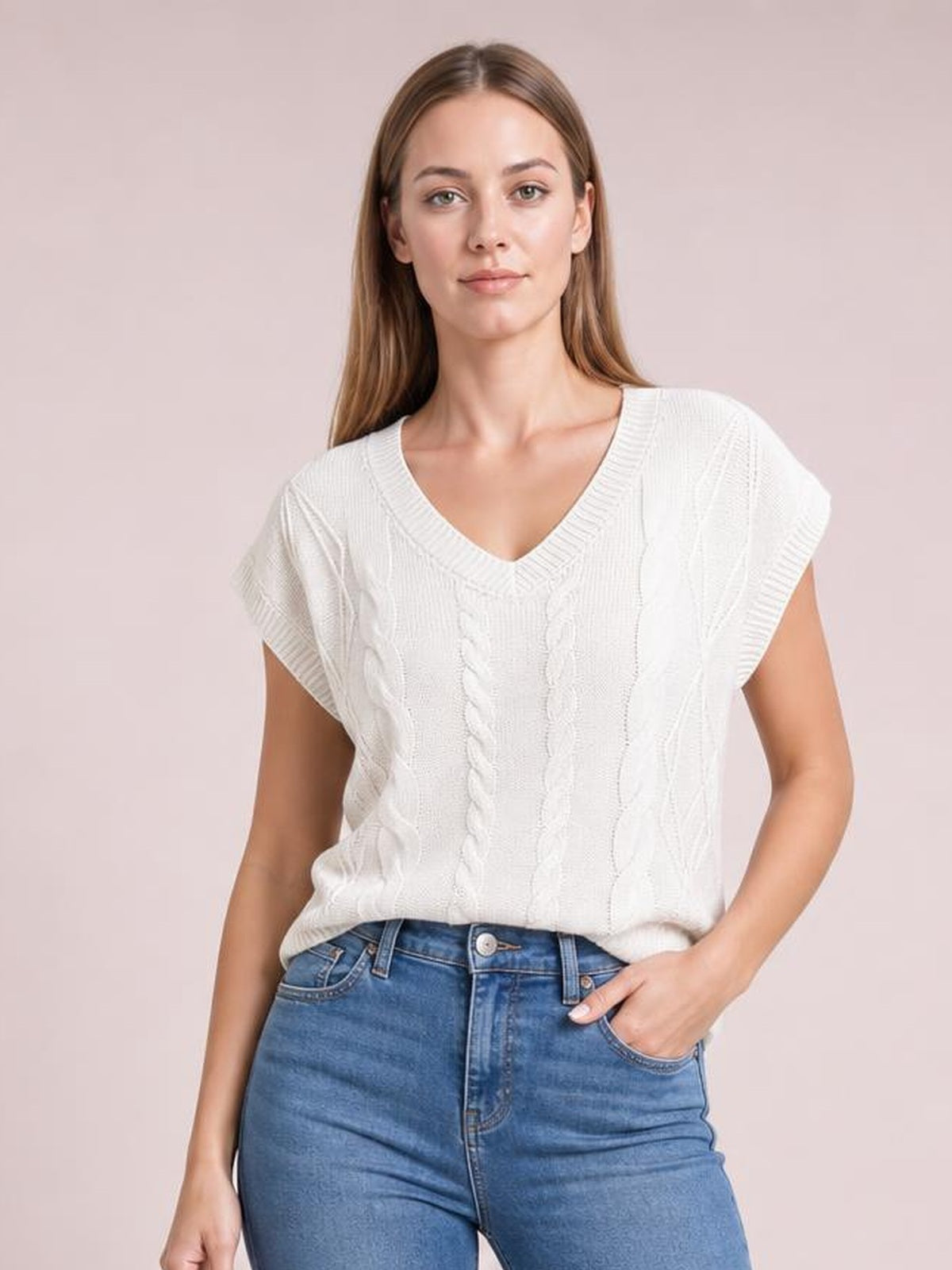 Model wears a white cable-knit V-neck short-sleeve top with a relaxed silhouette, ribbed trim, and textured vertical knit construction.