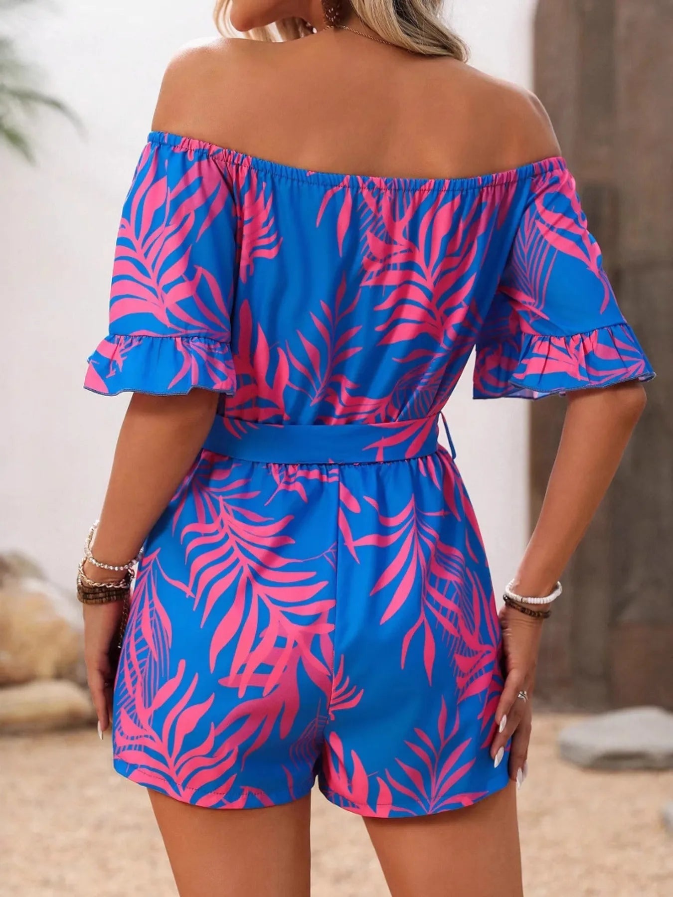 Tropical Print Off-Shoulder Romper with Tie and Ruffles.