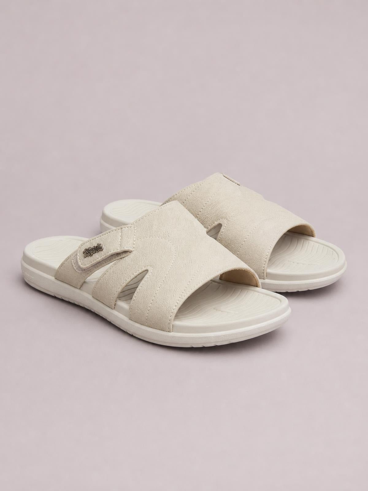 Cream PU leather cut-out platform slides feature wide textured straps, open toes, cushioned EVA soles, and a comfortable flat silhouette.