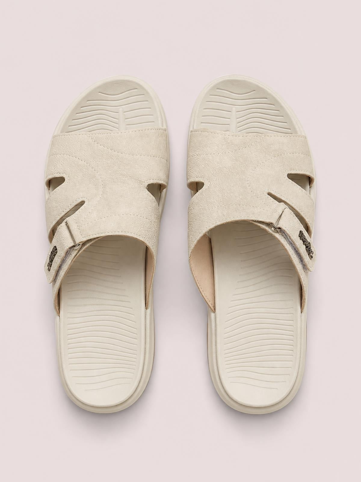 Cream cut-out platform slides feature textured crisscross straps, adjustable buckles, open toes, and thick cushioned EVA soles.