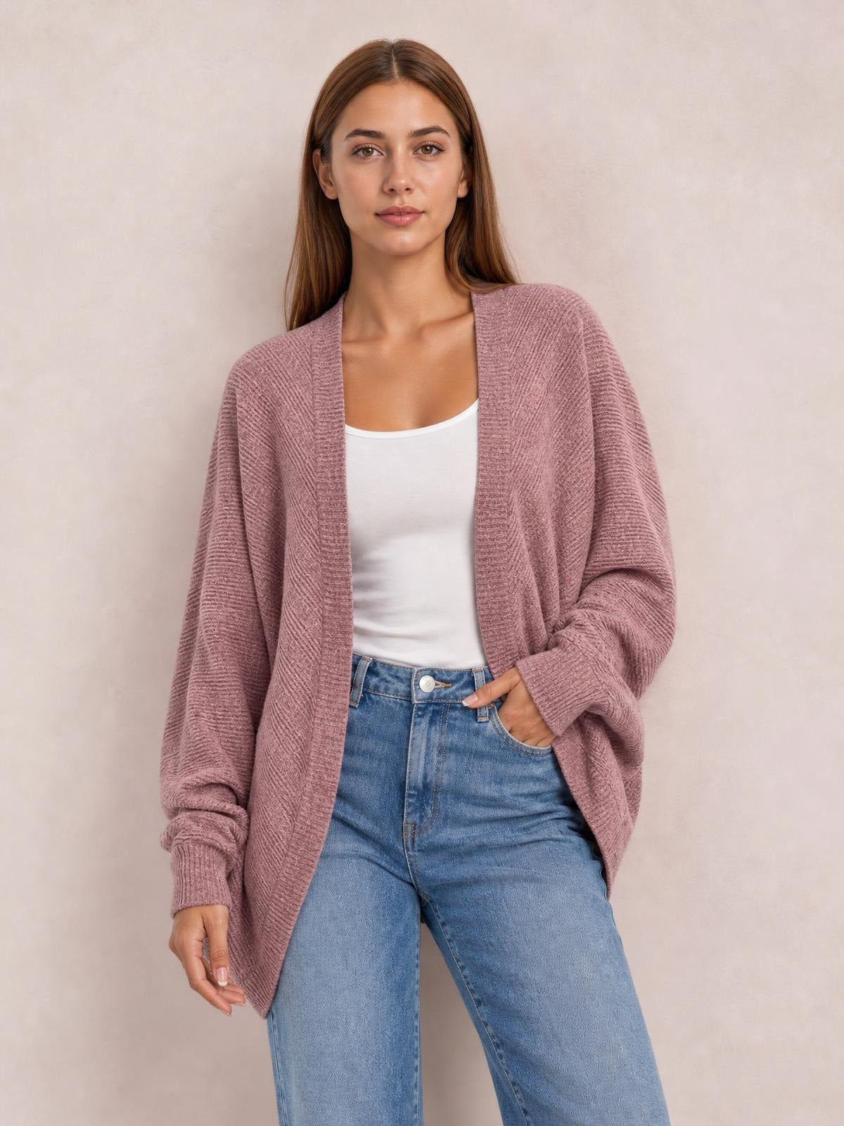 Model wearing a mauve casual knit open-front cardigan with relaxed sleeves and a long, draped silhouette over a white top and jeans.