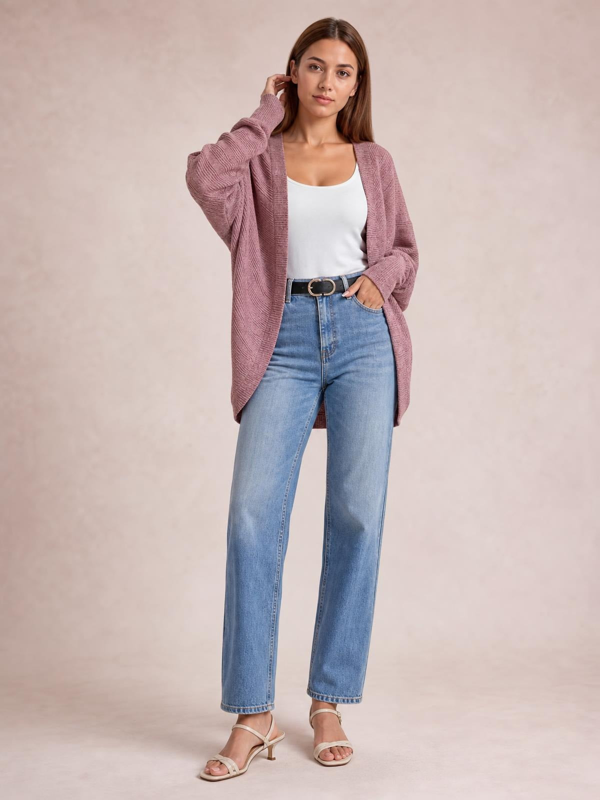 Model wearing a mauve knit open-front cardigan with long sleeves, textured construction, and a relaxed longline silhouette over a white tank top.