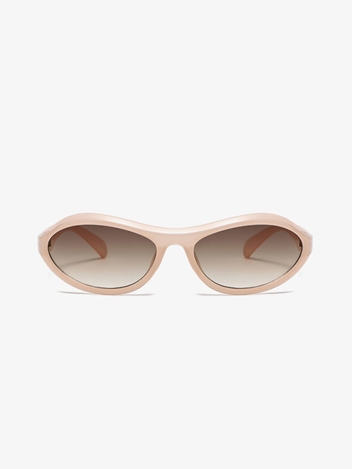 Rose beige cat-eye sunglasses feature a softly curved sculpted polycarbonate frame, tapered temples, and gradient brown lenses in a sleek retro silhouette.