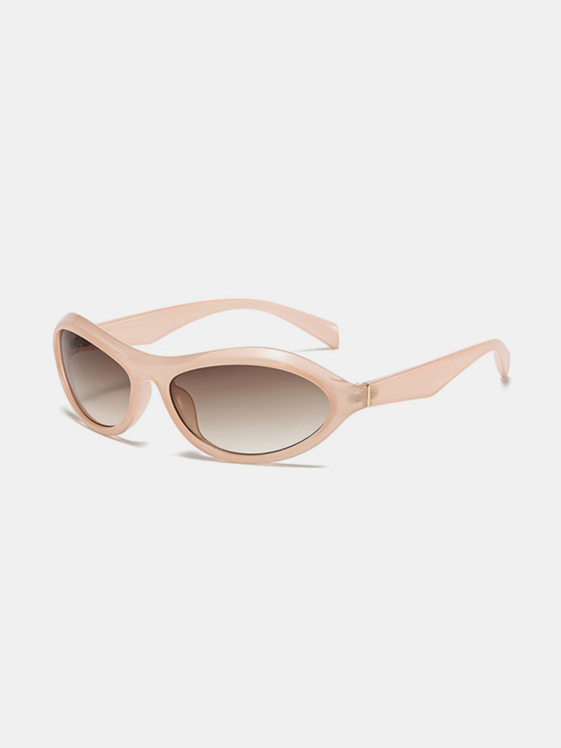Peach polycarbonate cat-eye sunglasses feature softly curved frames, brown gradient lenses, and tapered temples in a sleek retro silhouette.