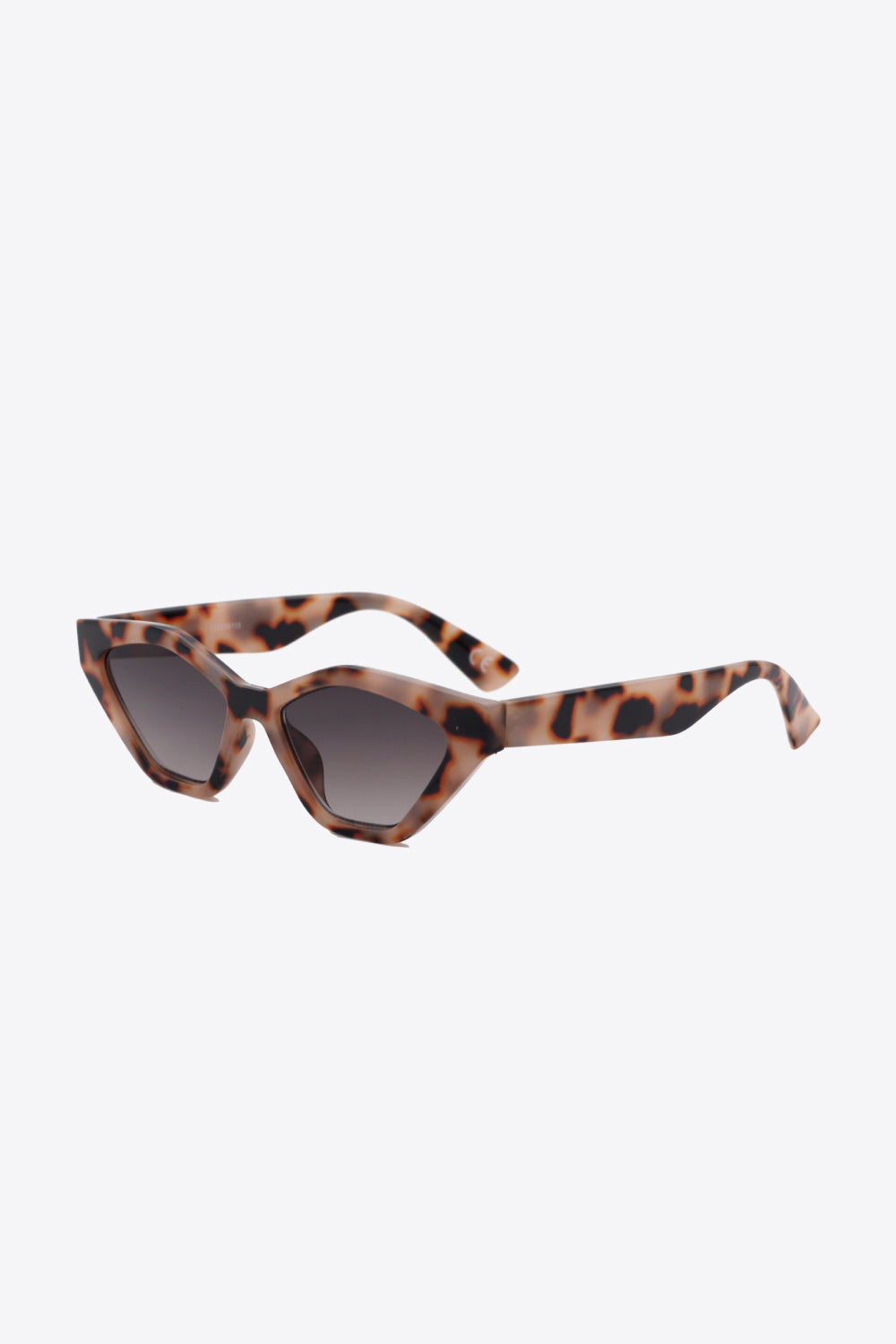 Tortoiseshell cat-eye sunglasses feature angular lenses, lifted outer corners, dark tinted lenses, and sculpted polycarbonate frames with curved temples.