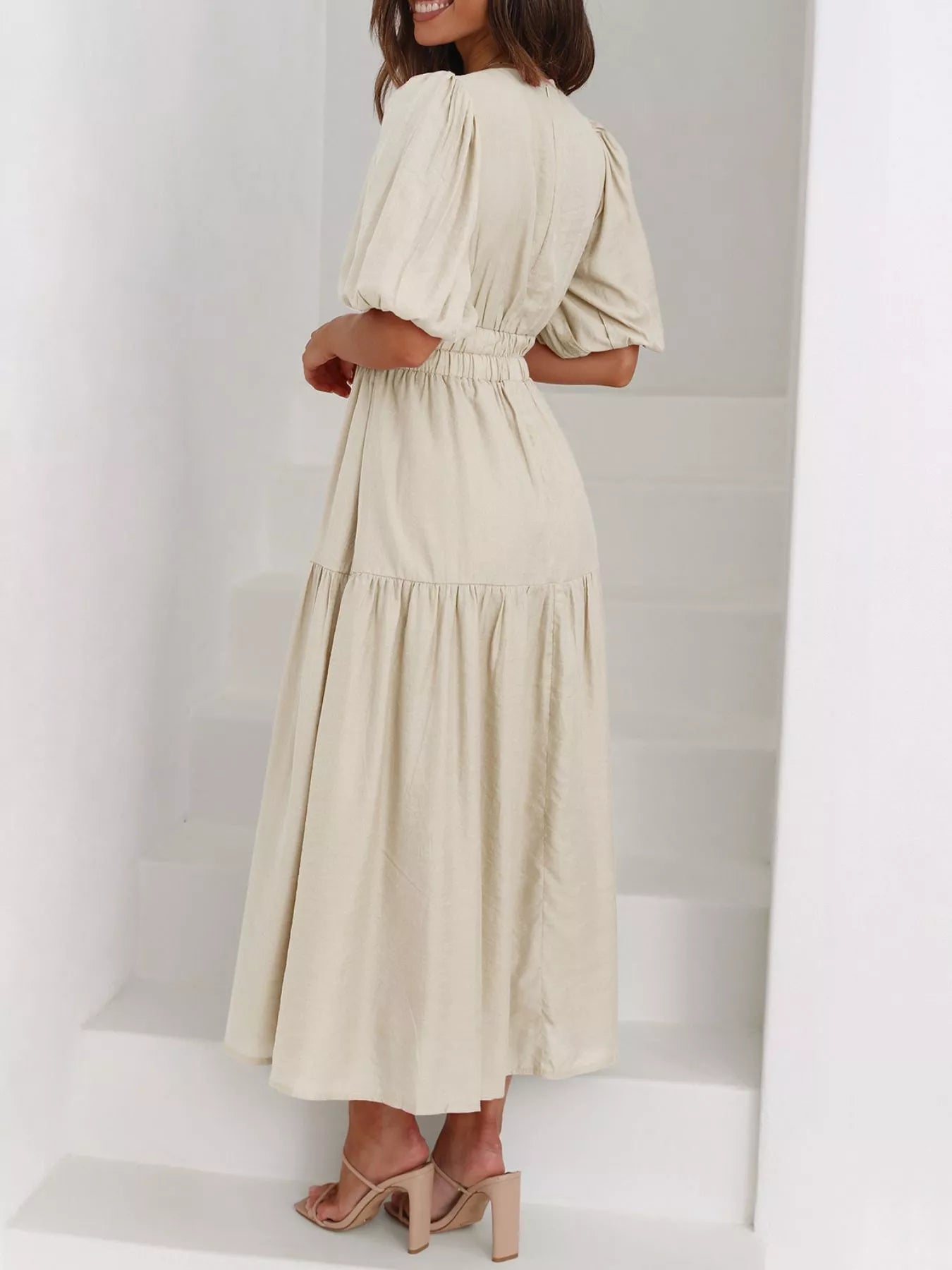 Cream tiered midi dress with a V-neck, smocked waist, and short puff sleeves