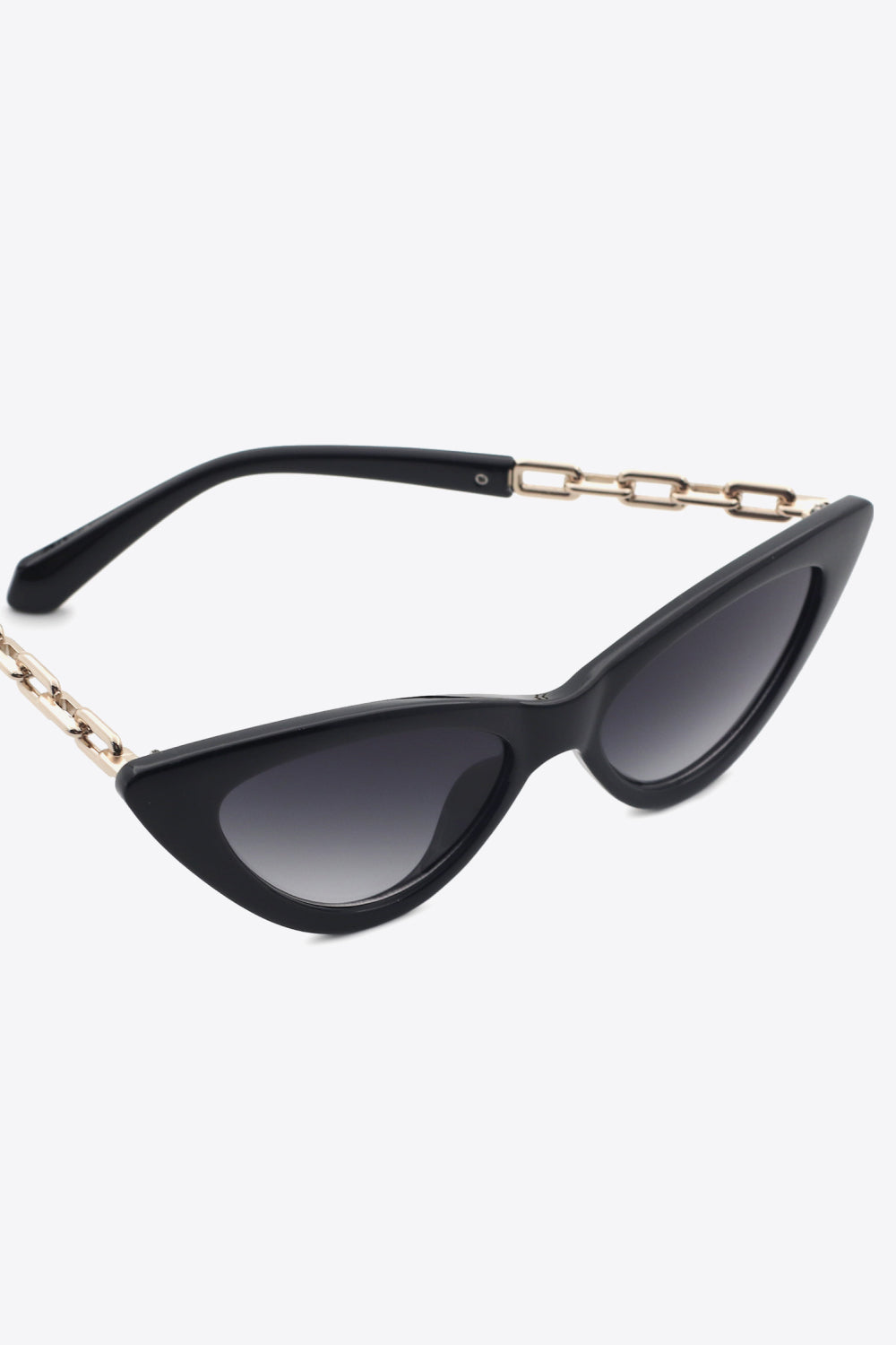 Black cat-eye sunglasses feature an upswept silhouette, dark gradient lenses, and polished chain detailing along the metal-plastic hybrid temples.