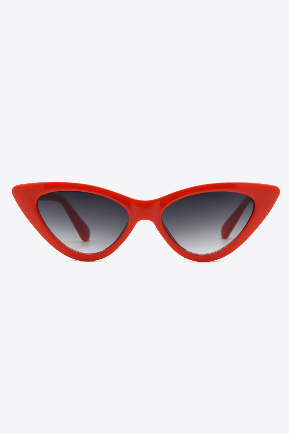 Bright red cat-eye sunglasses feature a bold upswept frame, dark gradient lenses, and a streamlined bridge with thick curved temples.