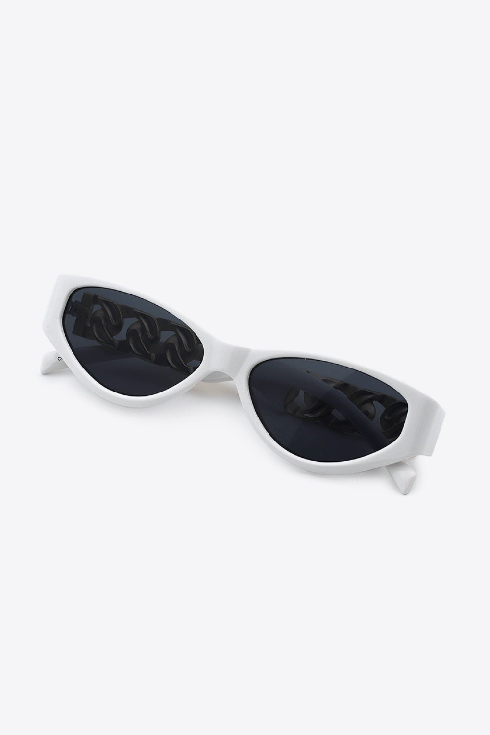 White cat-eye sunglasses with a sleek upswept silhouette, dark acetate lenses, and distinctive chain-inspired temple accents in a polished frame.