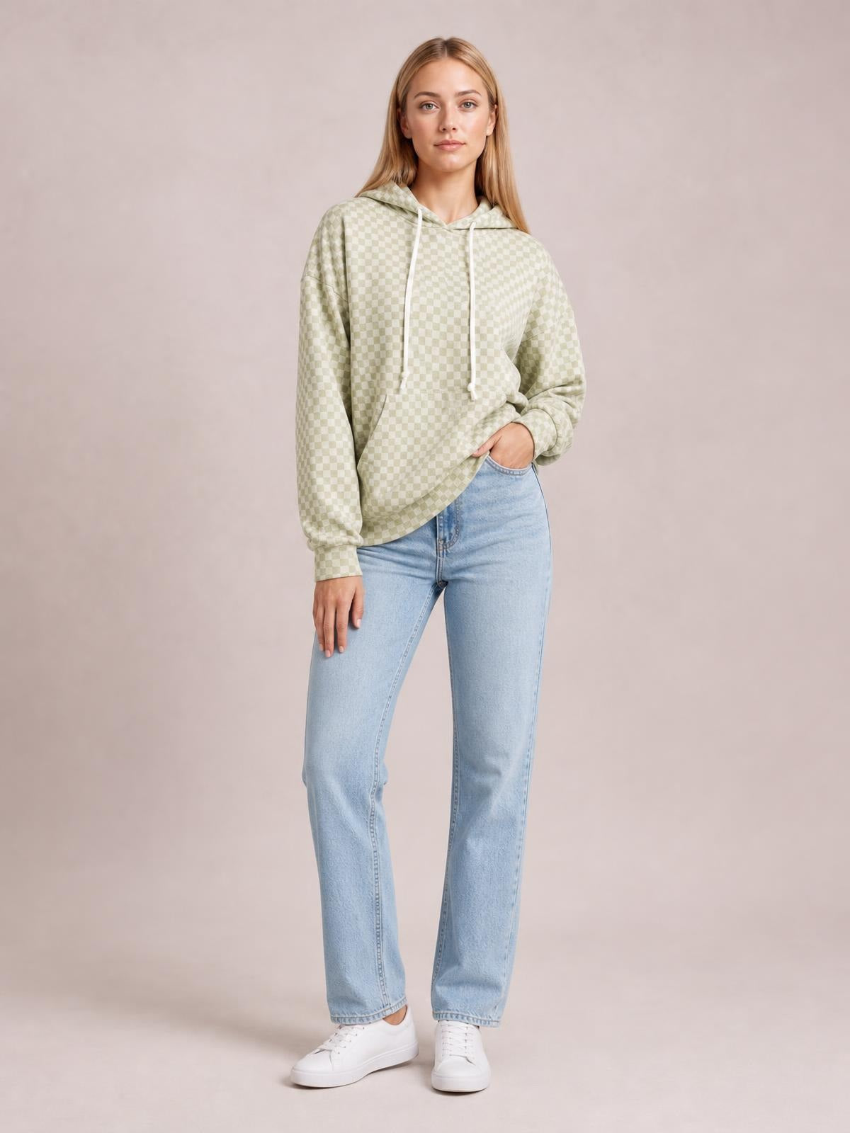 Model poses in a relaxed stance wearing a light green checkered hoodie with drawstring hood, long sleeves, ribbed cuffs, and a kangaroo pocket.