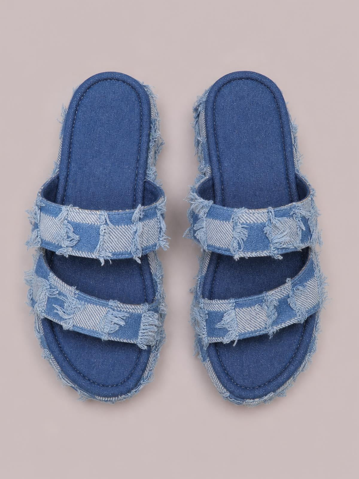 Blue checkered canvas platform sandals feature open toes, double wide straps, denim-like blue panels, and distressed raw frayed hems.