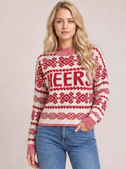 Model poses with one hand in her jeans pocket wearing a cream-and-red CHEERS Christmas sweater with a round neck, long sleeves, ribbed trim, and a relaxed silhouette.