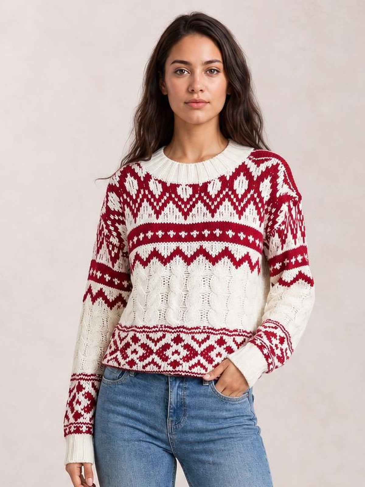 Model wears a red and cream Christmas cable knit long sleeve sweater with a ribbed crew neck, cuffs, hem, and fitted silhouette.