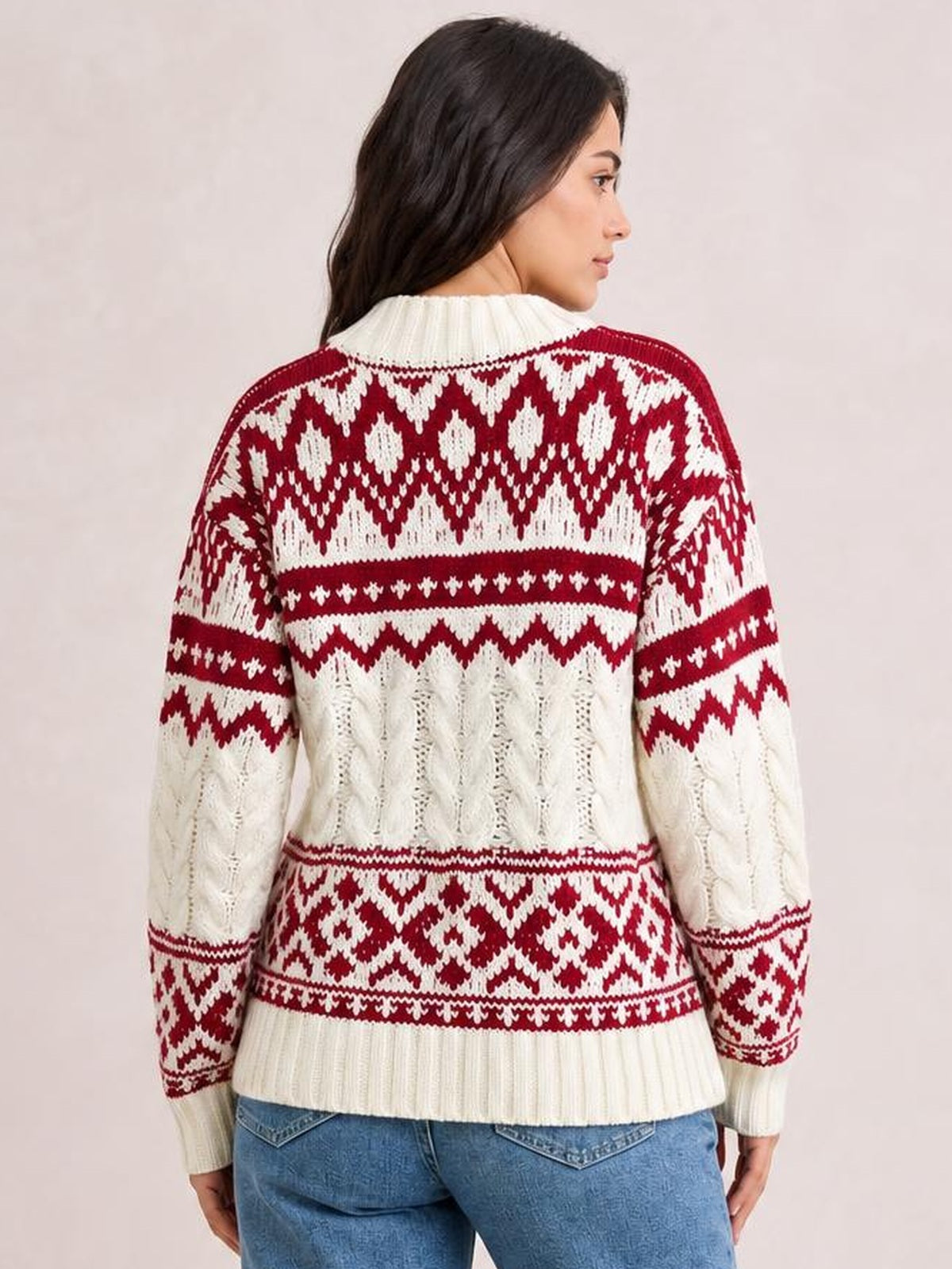 Model shown from the back wears a cream and red Christmas cable knit sweater with long sleeves, ribbed cuffs and hem, and a relaxed silhouette.