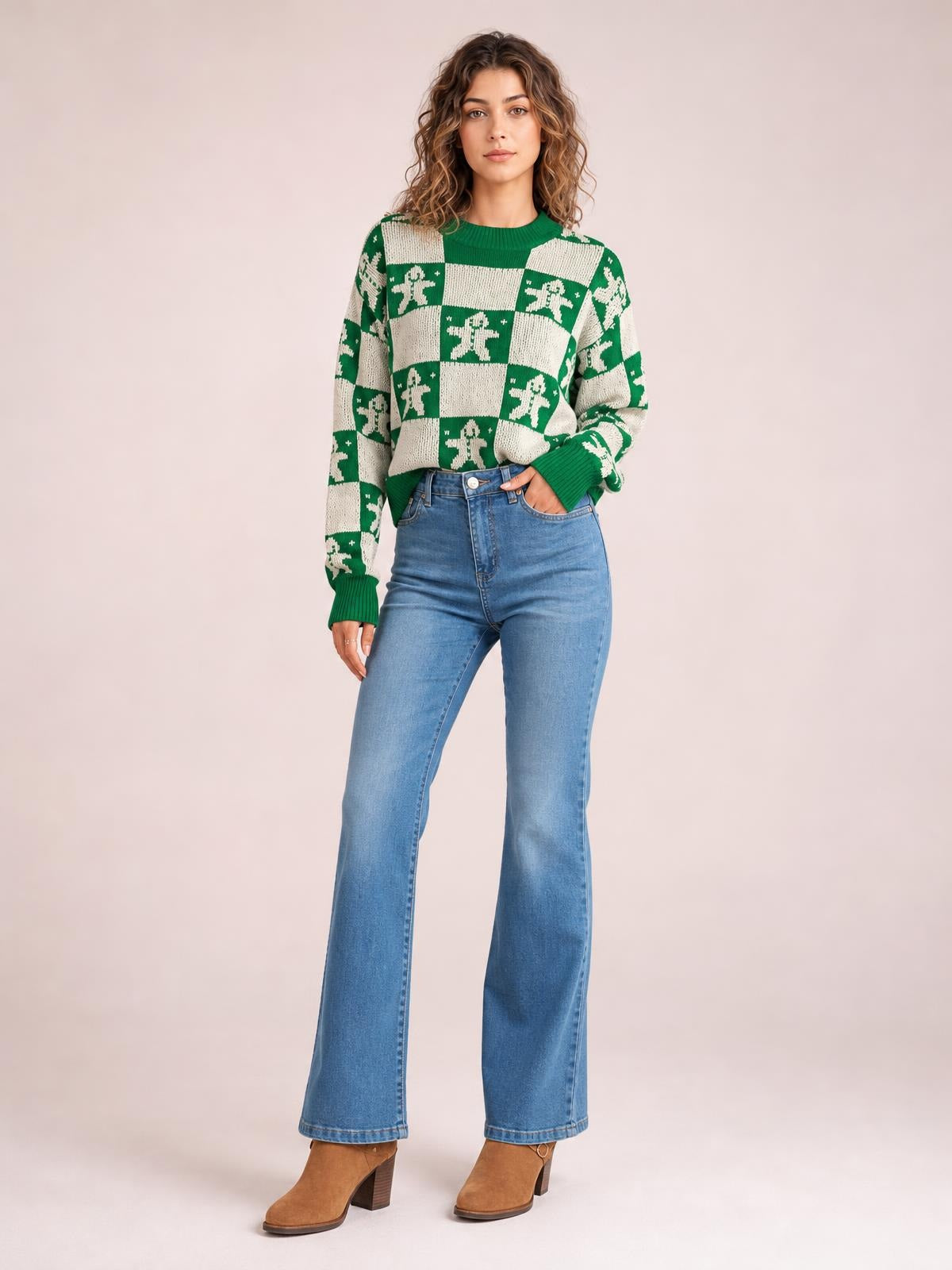 Model wears a green and cream Christmas checkerboard gingerbread sweater with a round neck, ribbed cuffs and hem, and a relaxed silhouette.