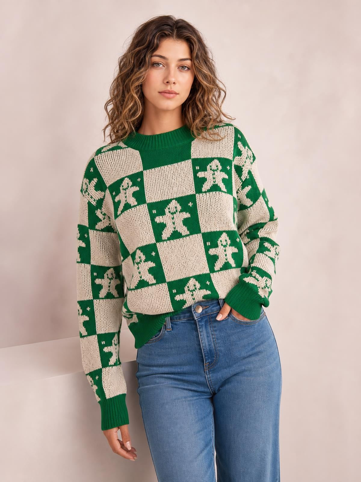 Model wears a green and cream Christmas checkerboard gingerbread sweater with a round neck, ribbed cuffs and hem, and a relaxed silhouette.