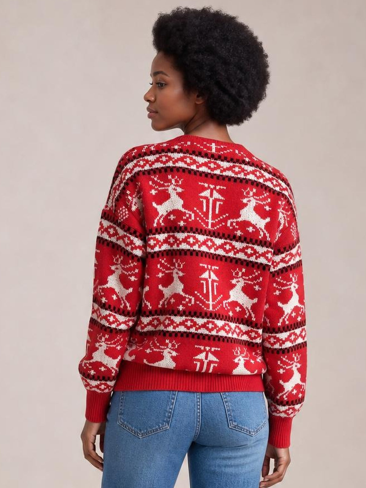 Model shown from the back in a red Christmas sweater with a round neck, long sleeves, ribbed cuffs and hem, and white reindeer pattern.