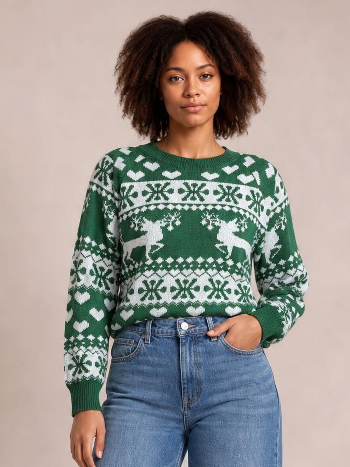 Model wearing a green Christmas sweater with a round neck, long sleeves, ribbed cuffs and hem, and white reindeer and snowflake patterns.