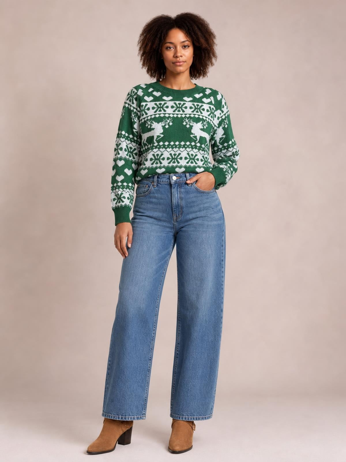 Model wearing a green Christmas element round neck sweater with long sleeves, ribbed cuffs and hem, white festive reindeer and snowflake pattern, and a relaxed fit.