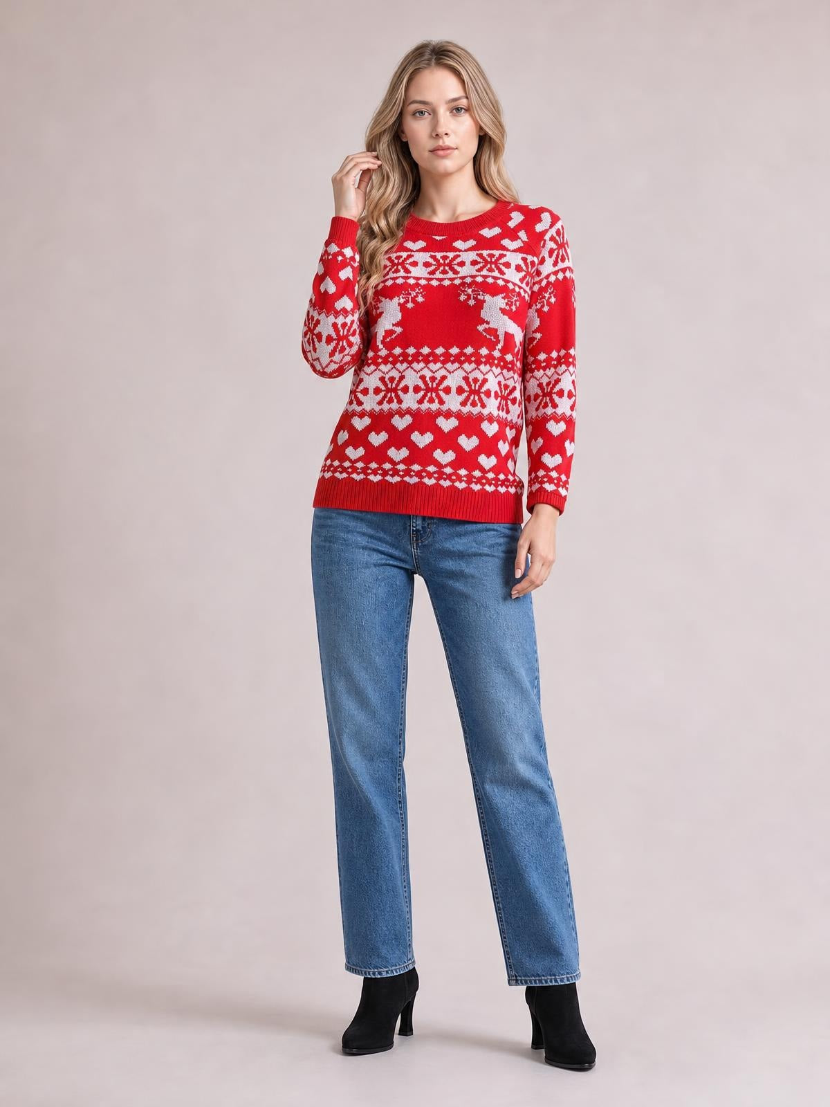 Model wearing a red Christmas sweater with a round neck, long sleeves, white holiday motifs, ribbed trim, and a straight relaxed silhouette.