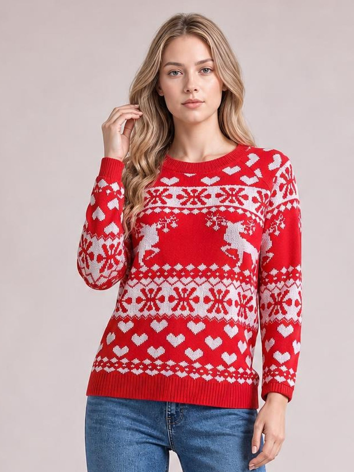 Model wearing a red Christmas sweater with a round neck, long sleeves, white fair isle patterns, hearts, reindeer, and a ribbed hem and cuffs.