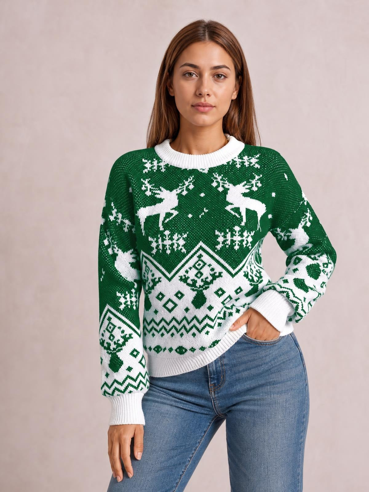 Model poses in a green and white Christmas sweater with a round ribbed neckline, long sleeves, festive reindeer pattern, and relaxed silhouette.