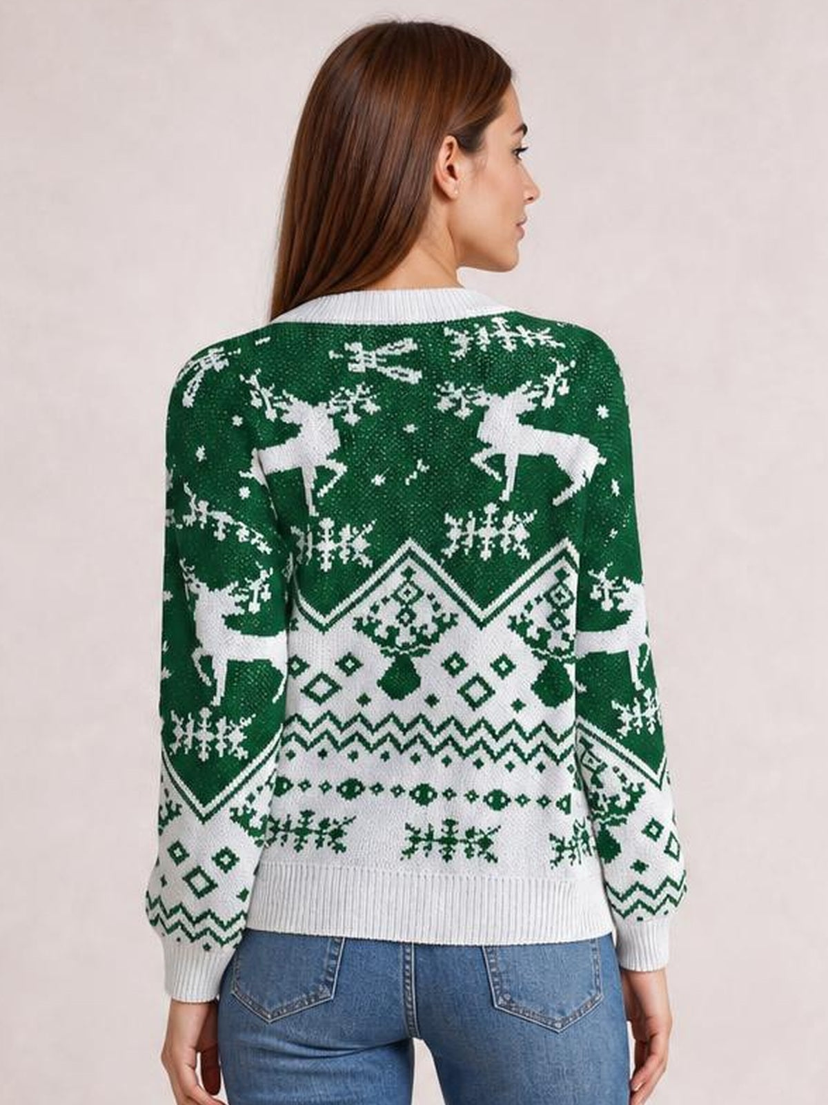 A model shown from the back wears a green and white Christmas sweater with a round neck, long sleeves, festive reindeer and snowflake patterns, and ribbed trim.