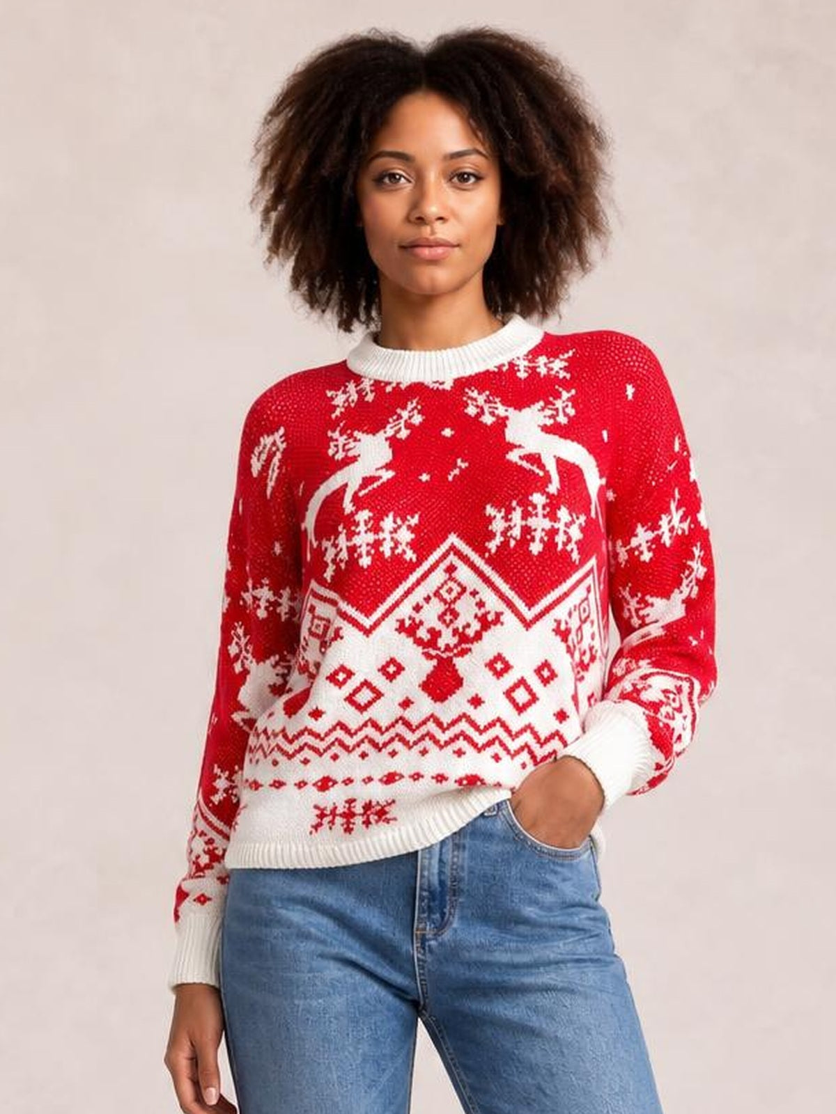 Model wearing a red and white Christmas round-neck long-sleeve sweater with reindeer, snowflake, and geometric knit patterns in a relaxed silhouette.