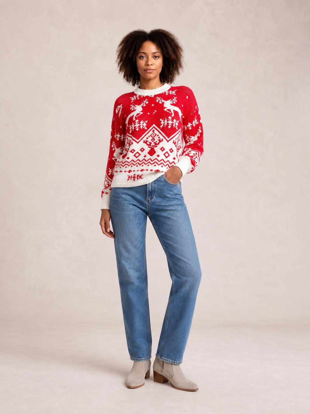 Model poses in a red Christmas sweater with a round neck, long sleeves, white ribbed trim, and festive geometric knit patterns in a relaxed silhouette.