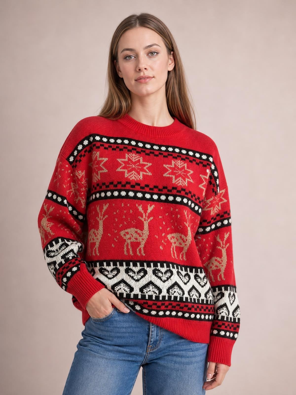 Model wearing a red Christmas round-neck long-sleeve sweater with black and white Fair Isle bands, festive reindeer and snowflake motifs, ribbed cuffs and hem.