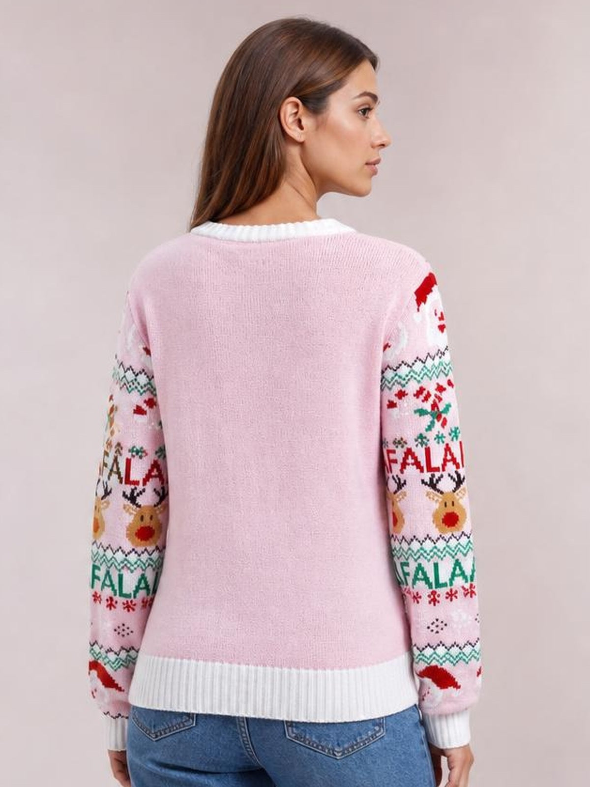 Back view of a woman wearing a pink Christmas Element round neck long sleeve sweater with festive patterned sleeves and white ribbed trim.
