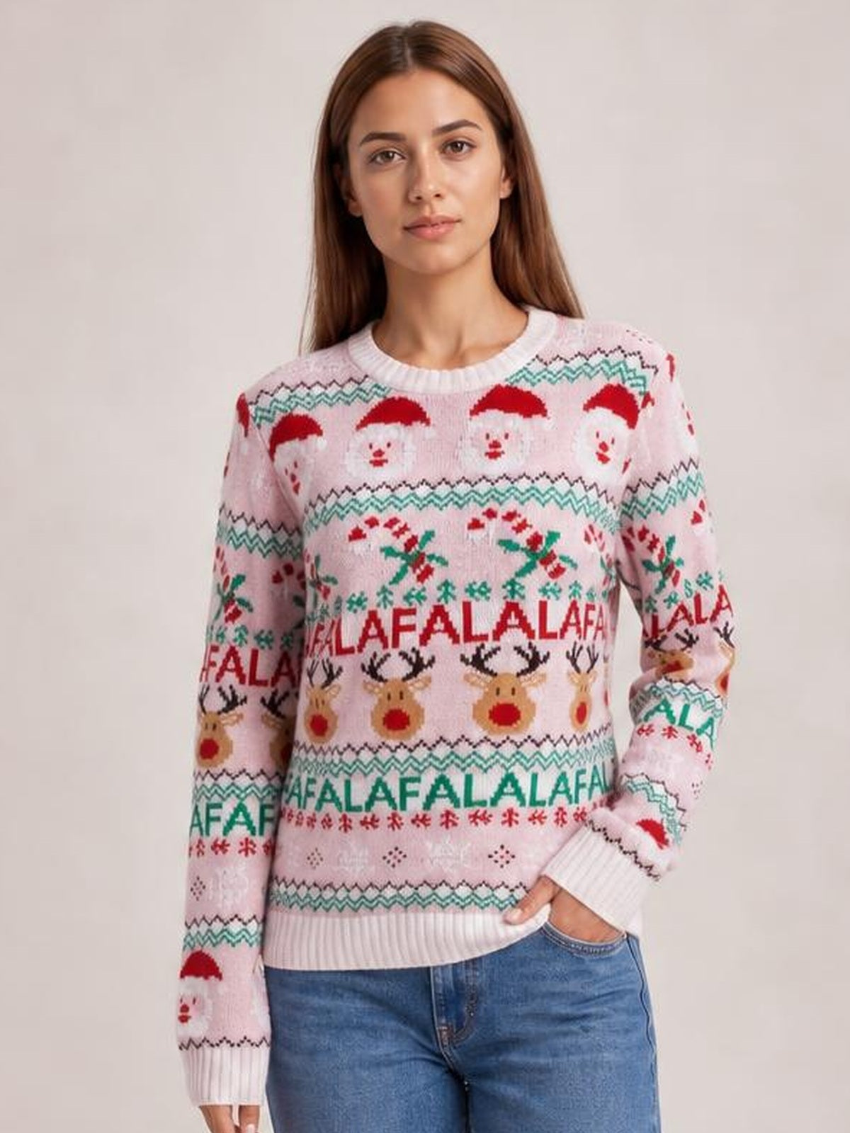 Model poses with one hand in her jeans pocket, wearing a pink Christmas round-neck long-sleeve sweater with Santa, reindeer, and festive patterned bands.