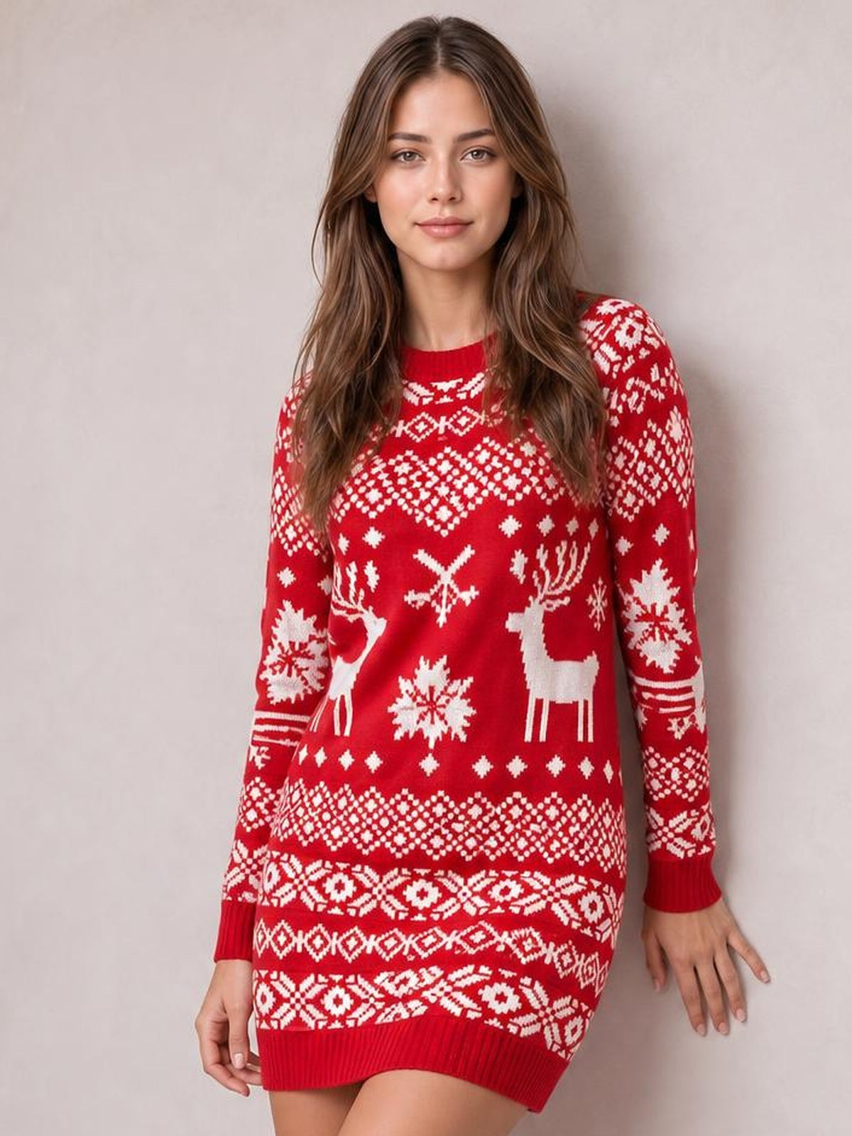 Model wears a red Christmas mini sweater dress with a round neck, long sleeves, white reindeer and snowflake motifs, and a fitted silhouette.