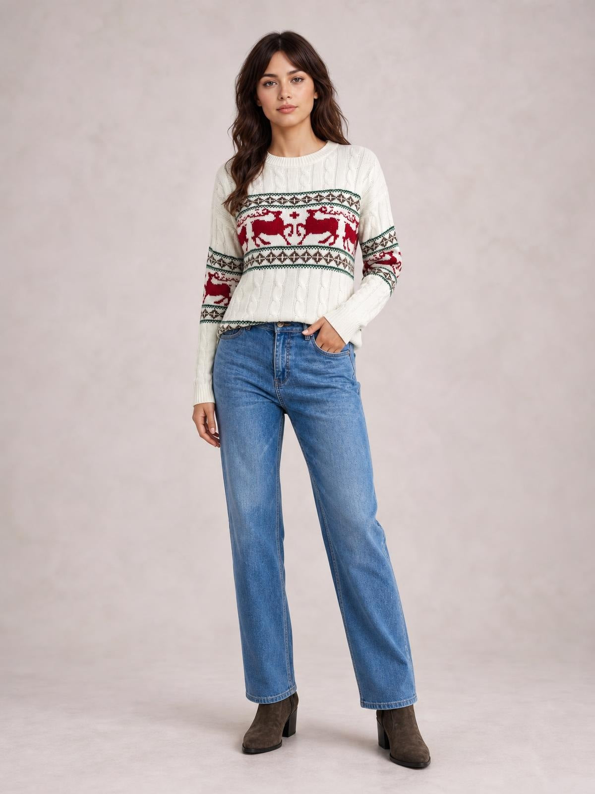 A model wears a white Christmas cable-knit sweater with red reindeer and geometric bands, a crew neck, long sleeves, and a relaxed silhouette.
