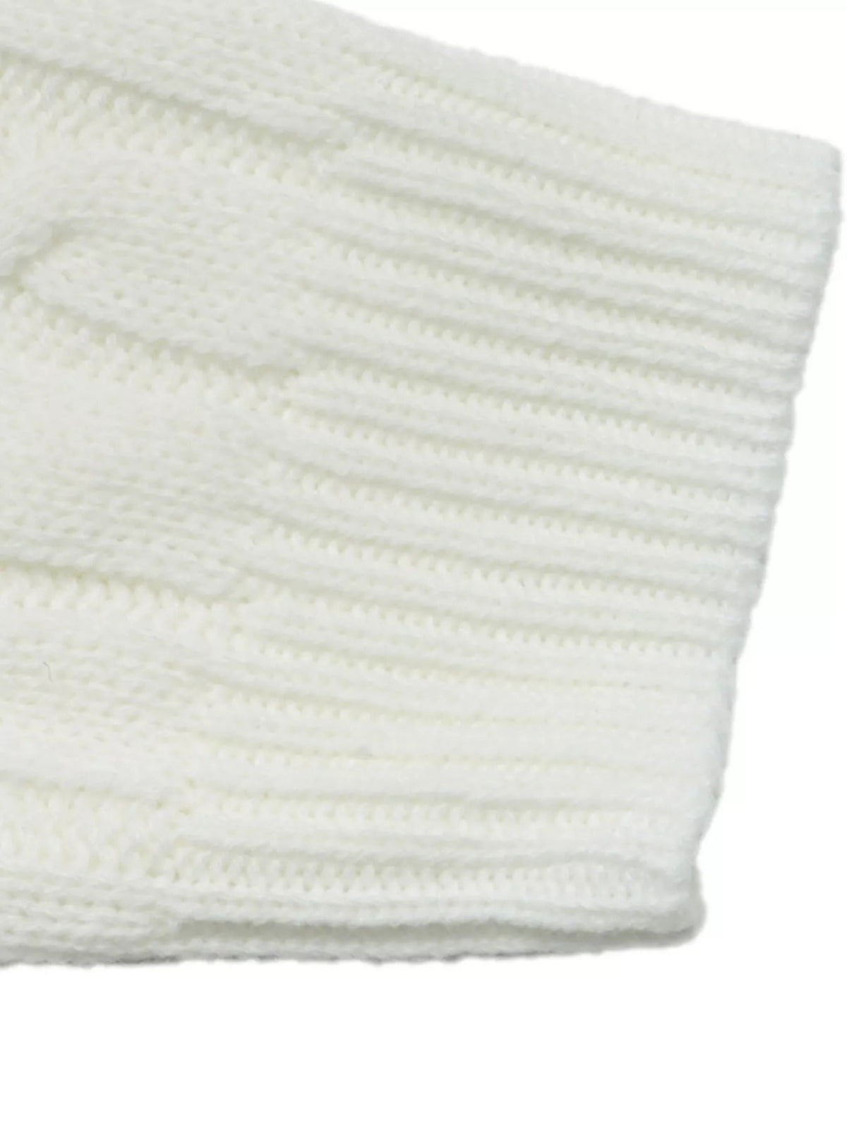 Close-up of an ivory sweater showing stretchy cable-knit texture with raised horizontal ribbing and a soft, structured construction.