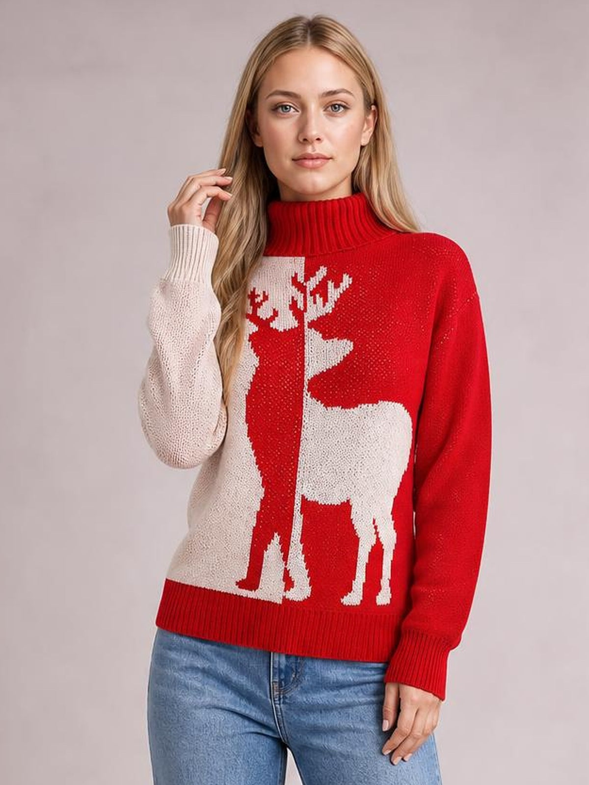 A model poses in a red-and-cream ribbed Christmas reindeer turtleneck sweater with long sleeves, a relaxed silhouette, and contrasting knit reindeer motifs.