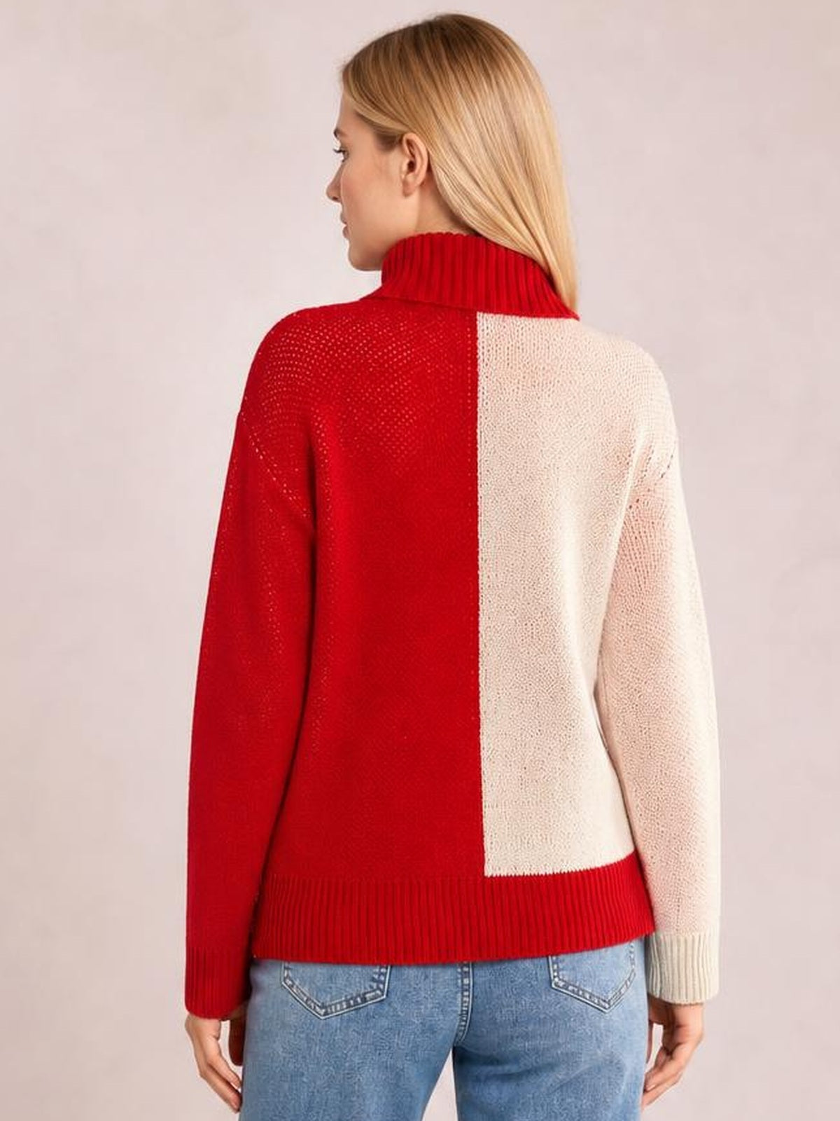 Model shown from behind wearing a red and cream color-blocked ribbed turtleneck sweater with long sleeves, a relaxed silhouette, and ribbed cuffs and hem.