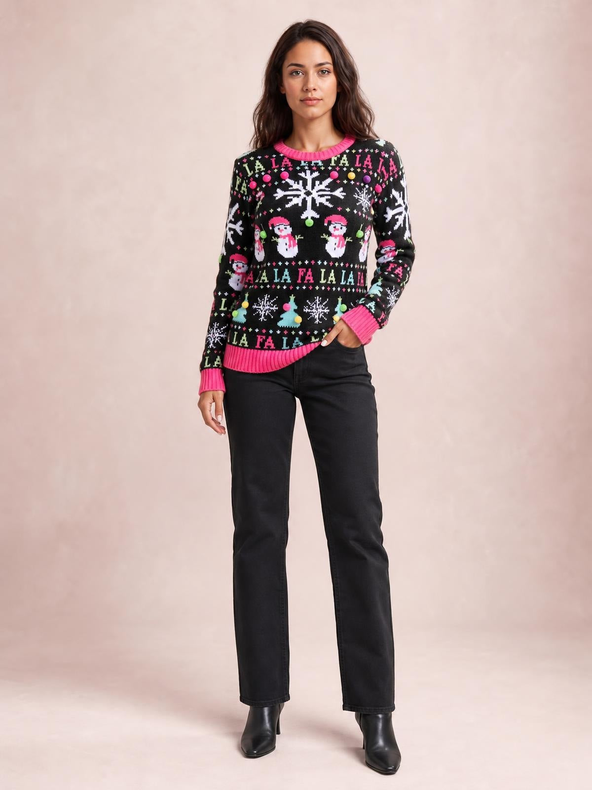 Model wearing a black Christmas ribbed trim sweater with pink cuffs and hem, long sleeves, festive snowflake and snowman motifs, and a relaxed silhouette.